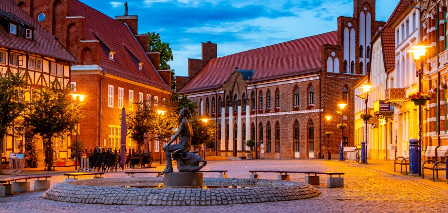 Schuhmarkt bei abendlicher Stimmung mit dem Brunnen und Rathaus im Hintergrund